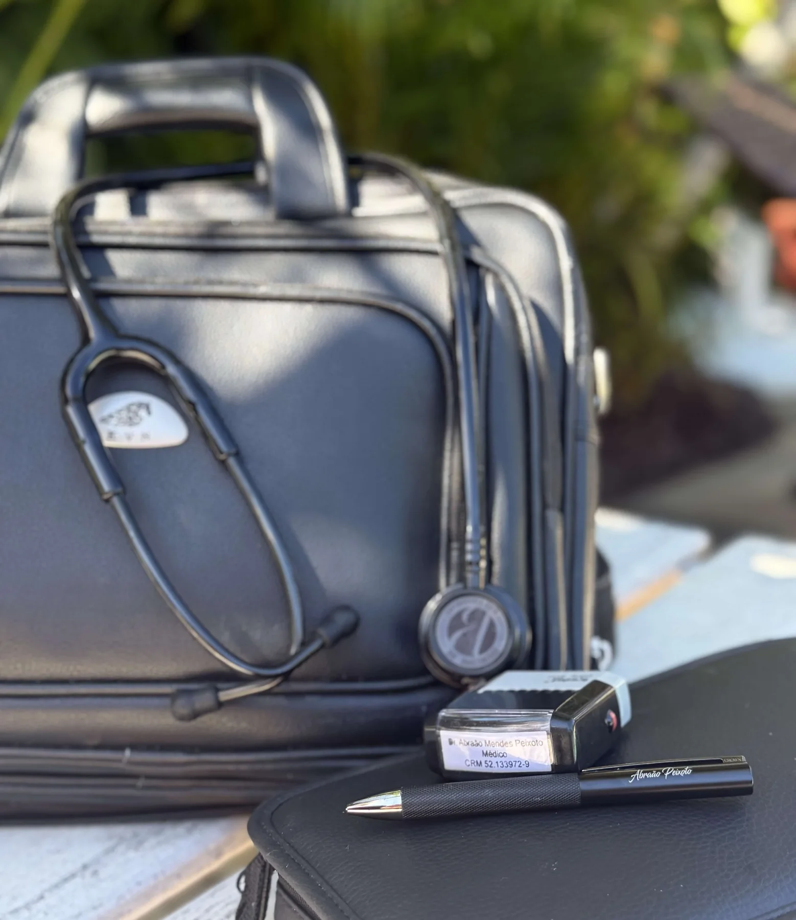 Medical bag, stethoscope, physician stamp and pen used during private visits